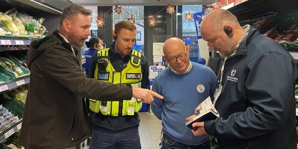 Business crime officer PC Mike Lee, left, and Vinnie Geaves, of Colchester BID, talking to a security supervisor and store manager