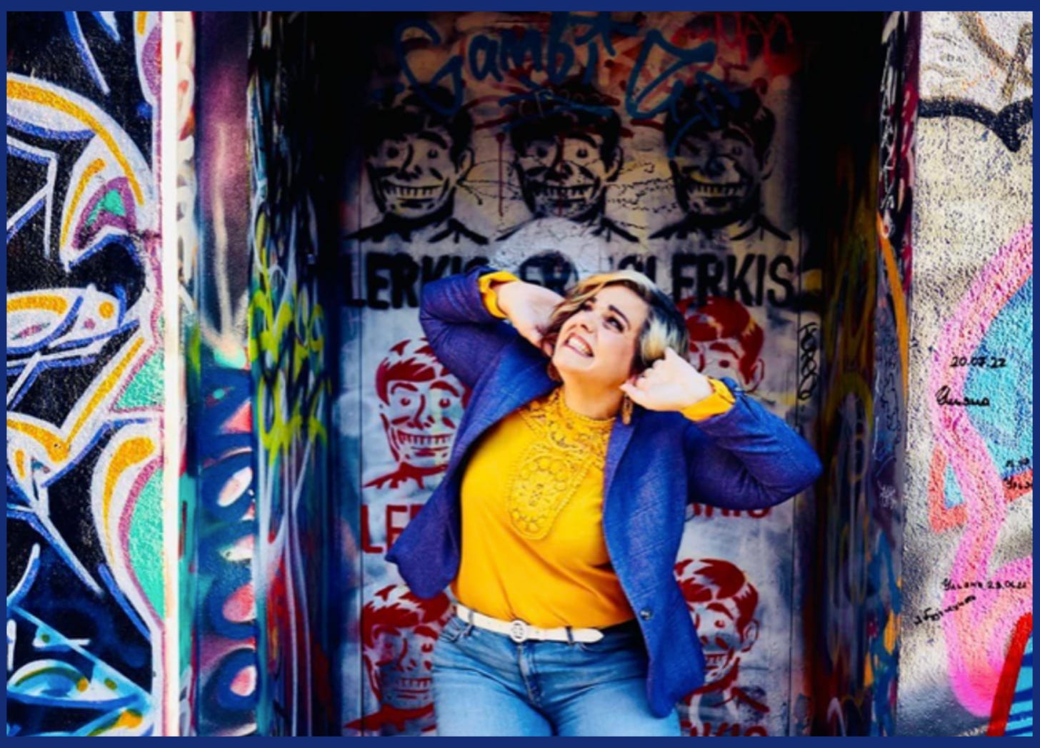 Woman covering her ears poses in front of a graffitied wall. Unmasking Autism Blog: I Can't Hear You. Autistic Blog | Auditory Processing Disorder: from inside Angela's Autistic mind.