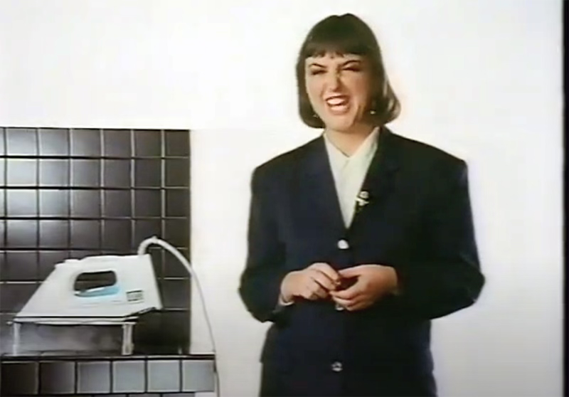 Tefal Iron advert 1990s, women pulling a face as she stands next to an iron