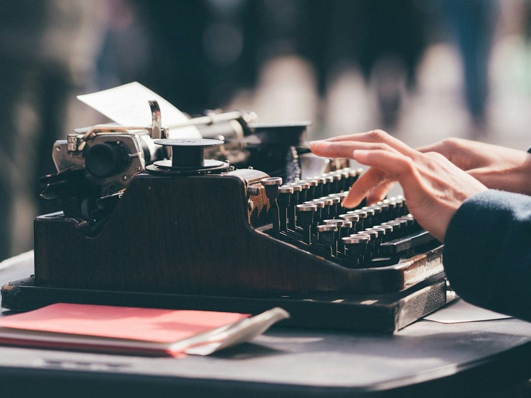 person using black typewriter