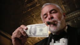 Lowangle Shot Of Man In Tuxedo Lighting Cigar With Us100 Bill High-Res  Stock Video Footage - Getty Images