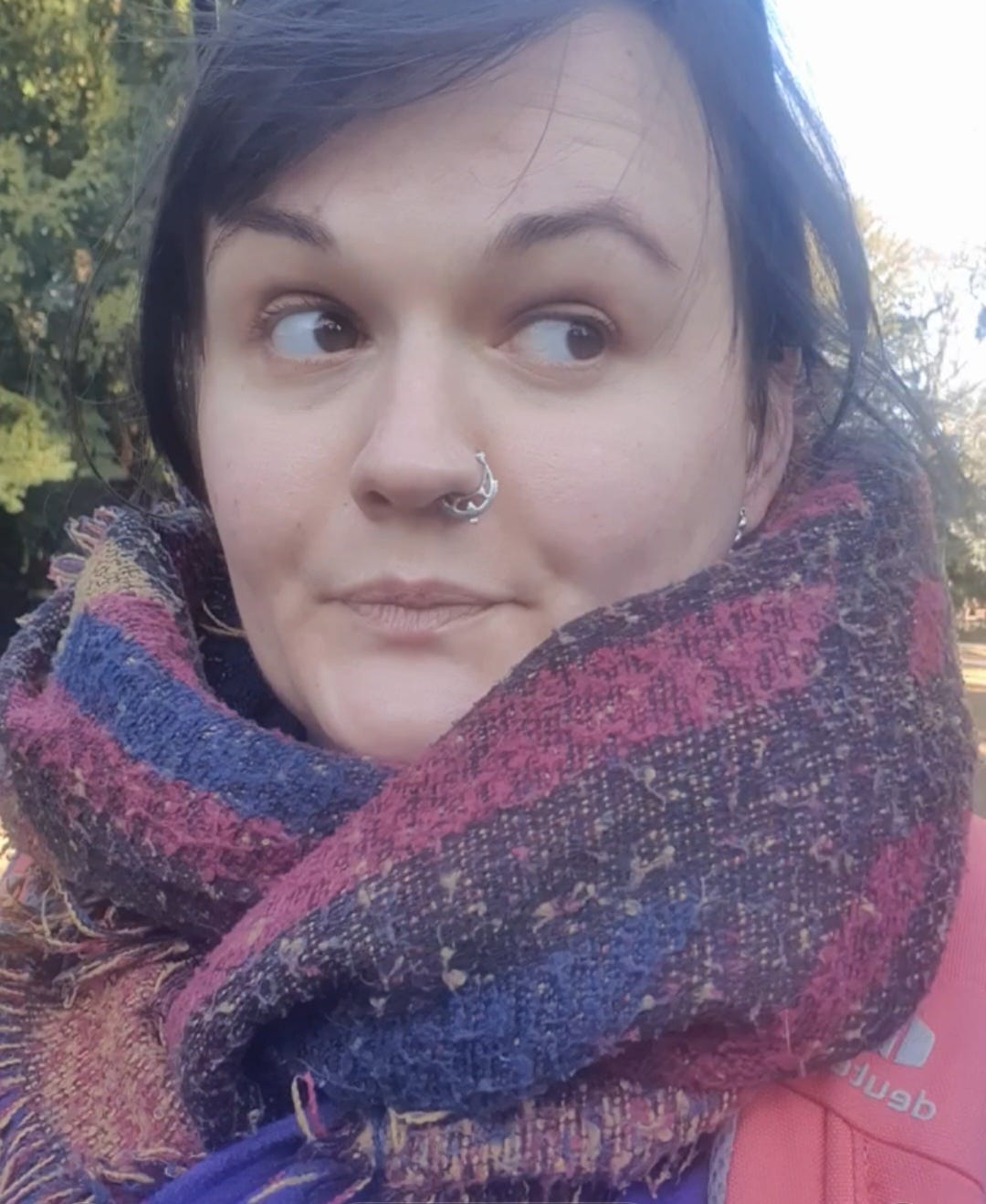 Lucy wears a thick scarf while giving bombastic side eye in her local park