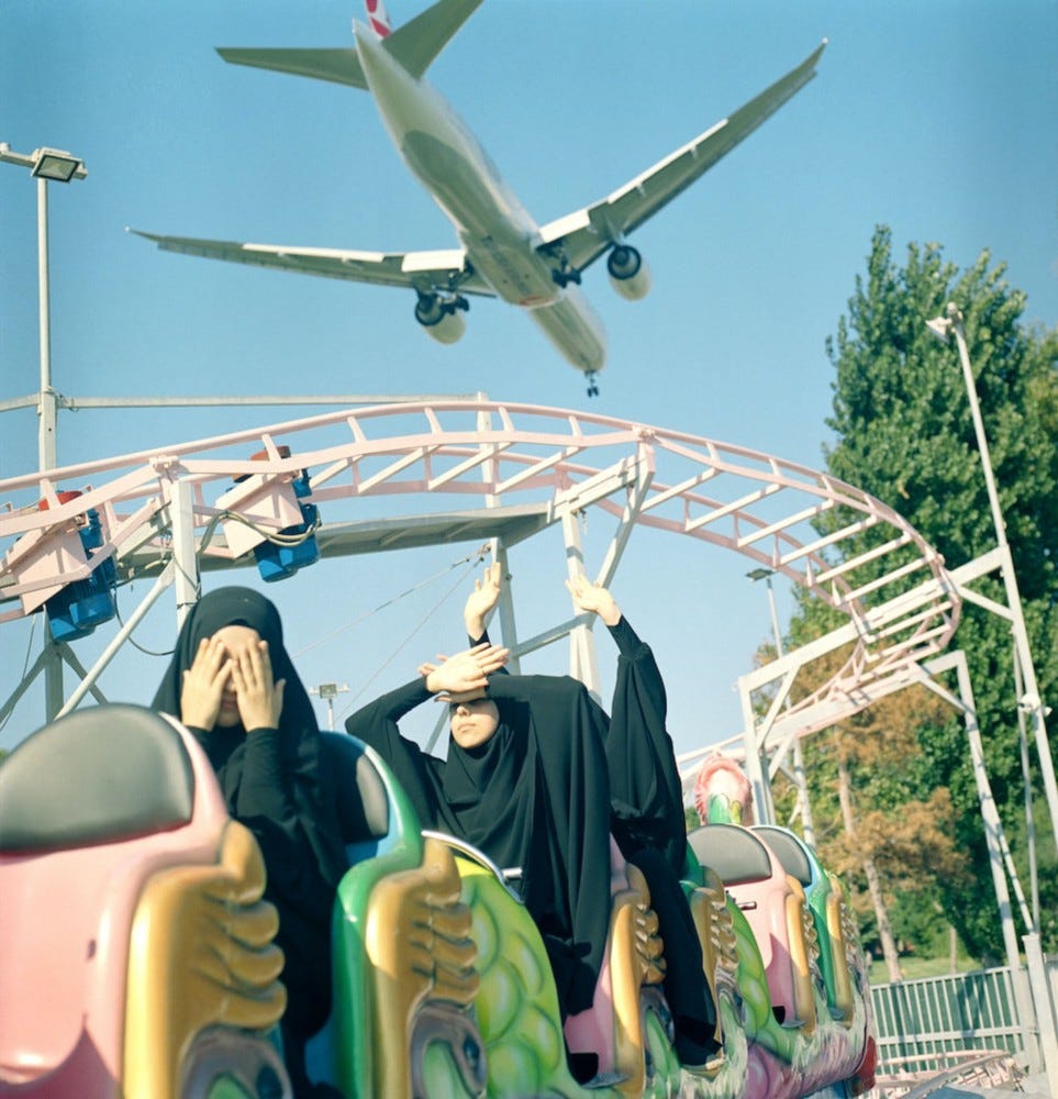 A low-flying plane above students at a funfair. From the series ‘Hafiz: The Guardians of Quran’. Istanbul, Turkey, 2018.