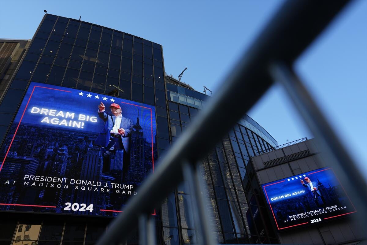 Video boards outside Madison Square Garden display information about Sunday's planned rally by Donald Trump.