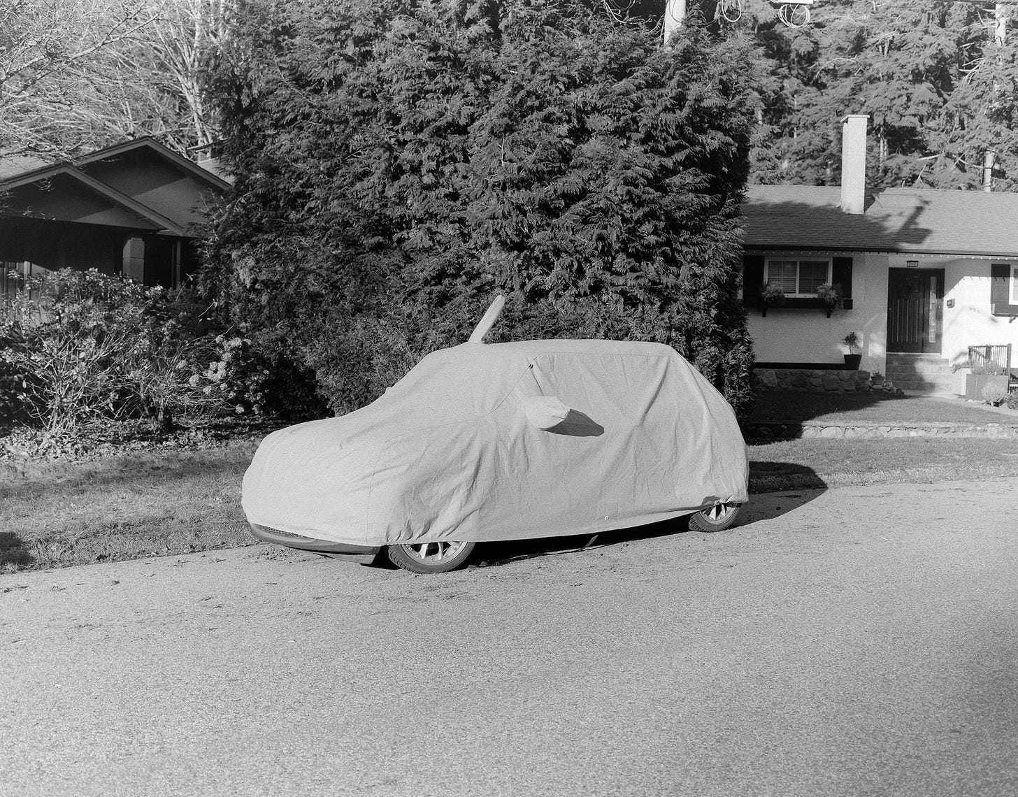 A parked car hidden under a protective cover