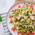 close up of a plate with italian chopped salad, ringed in chopped tomatoes