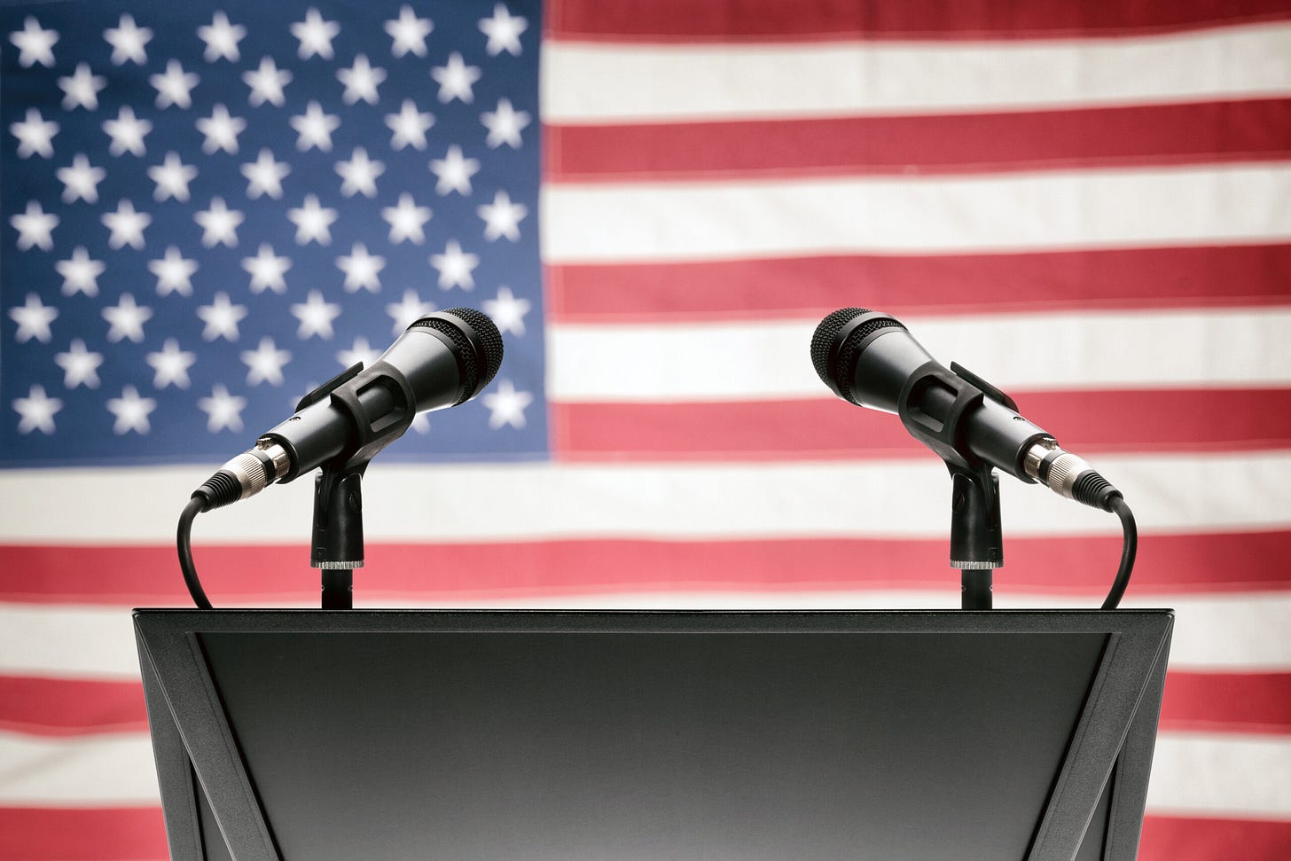 Pulpit with two microphones and USA flag on background