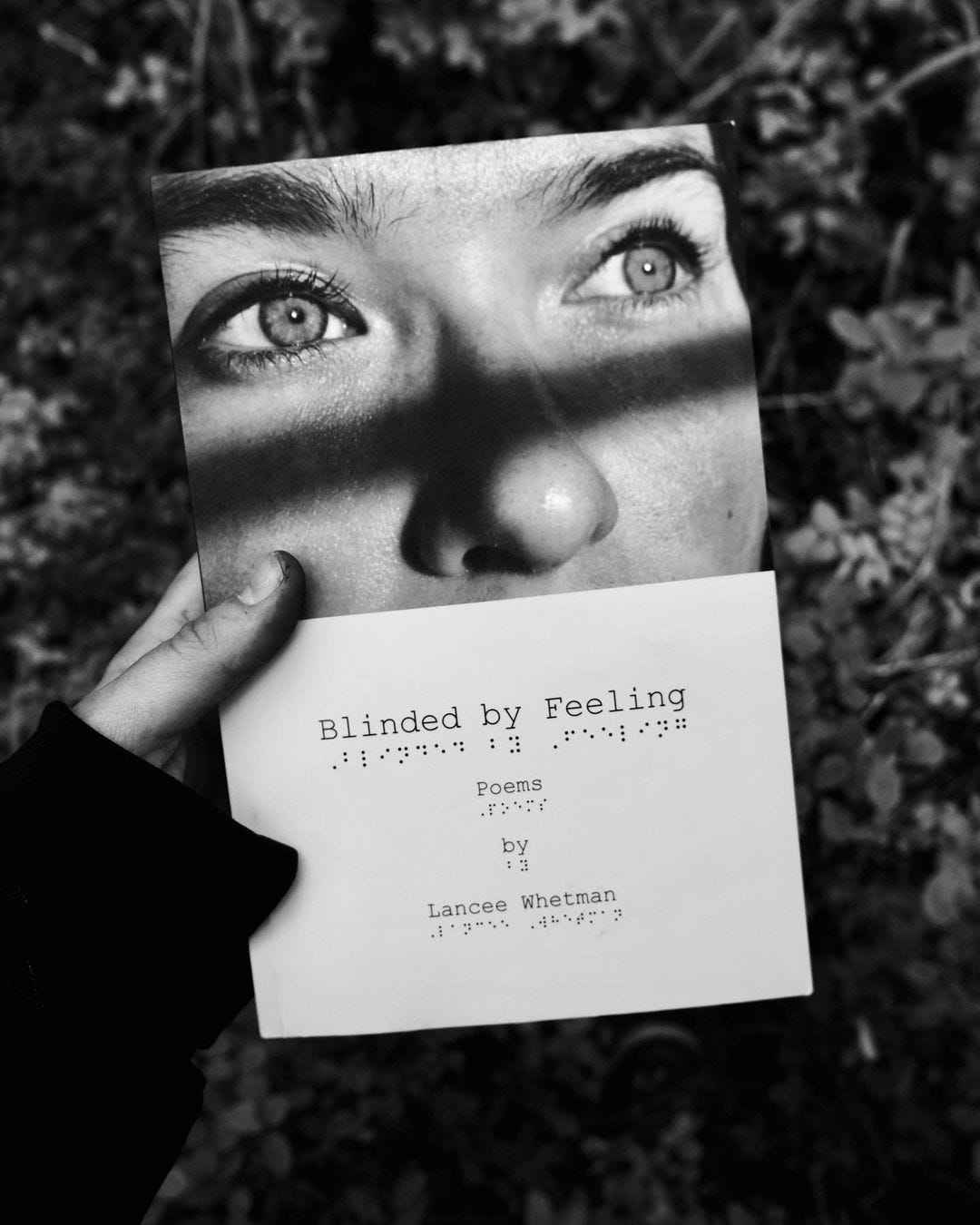 a black and white photo of Lancee Whetman's poetry book called Blinded By Feeling