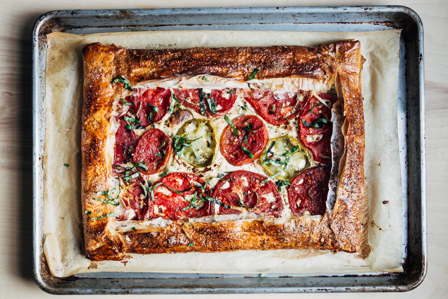 A baked tomato tart with a golden crust