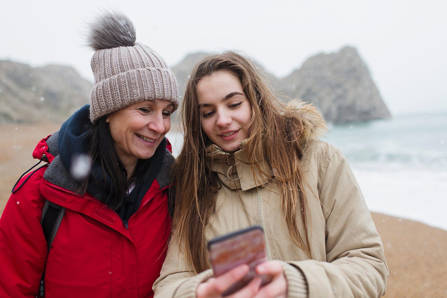 Mother and daughter looking at phone together