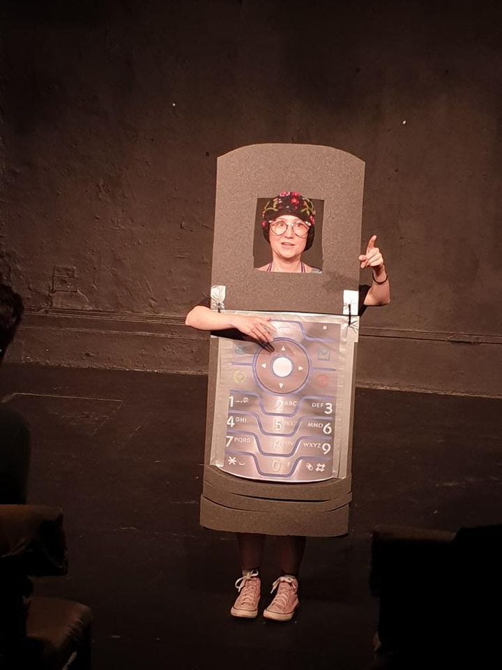 woman dressed as flip top phone on stage