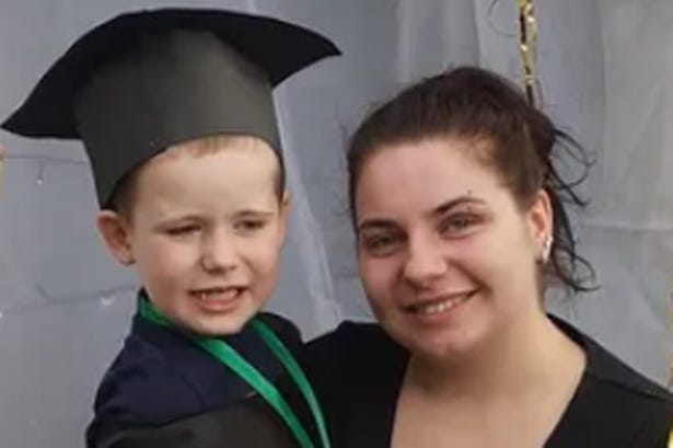 Chloe Barratt holding her son Abel, who is in a graduation outfit