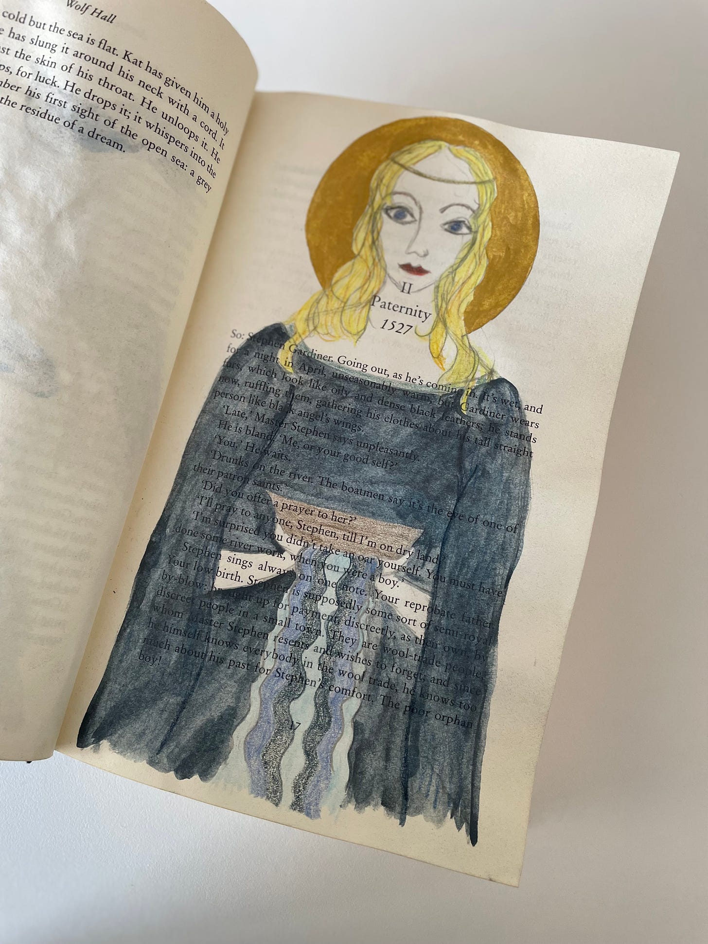 An image of a painted saint holding a boat, painted over the text of a book.