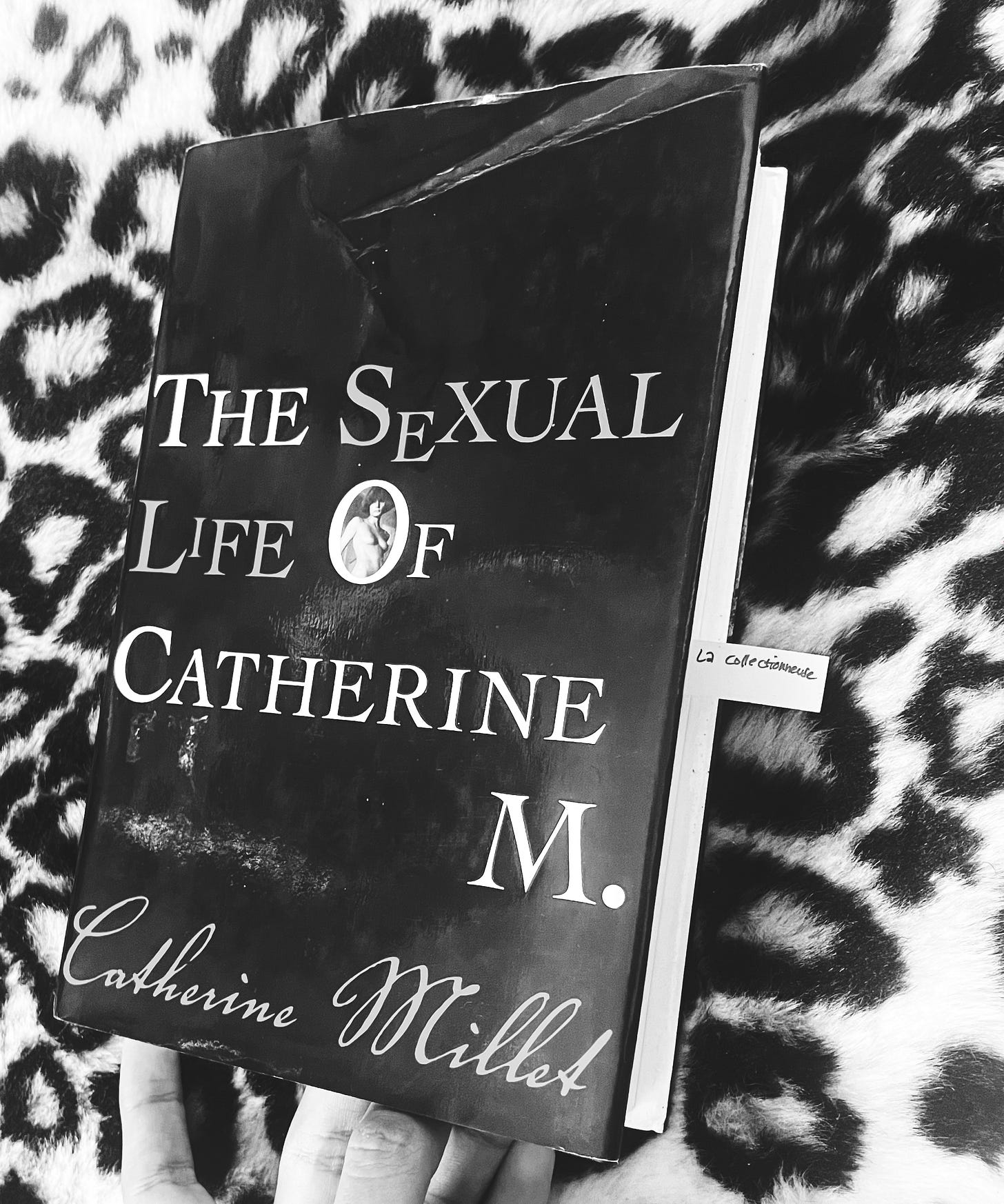 Catherine Millet's book The Sexual Life of Catherine M. with a book tag that says "La Collectionneuse"