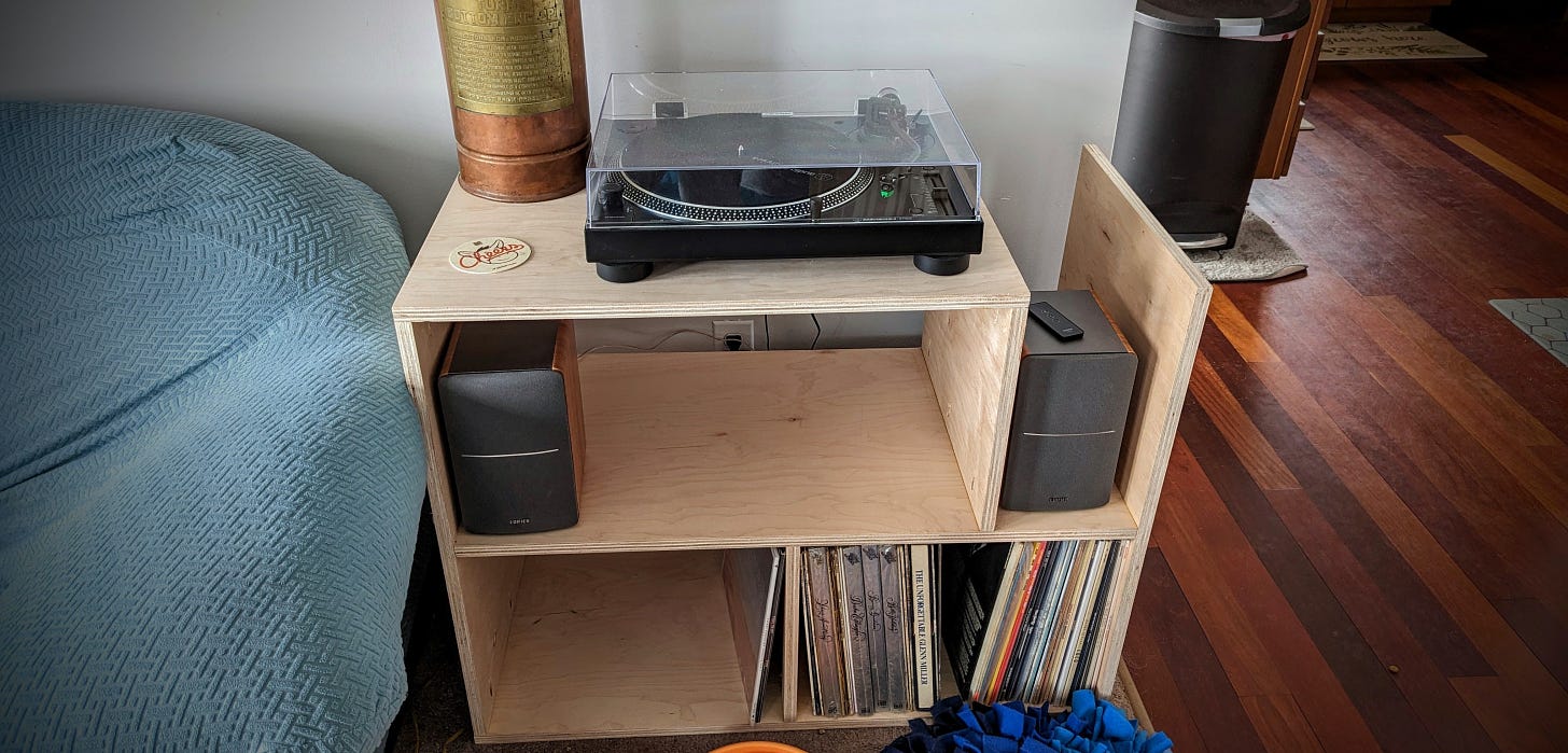 Photo of Kate's record player stand, which includes two shelves for records. The record player sits on the top