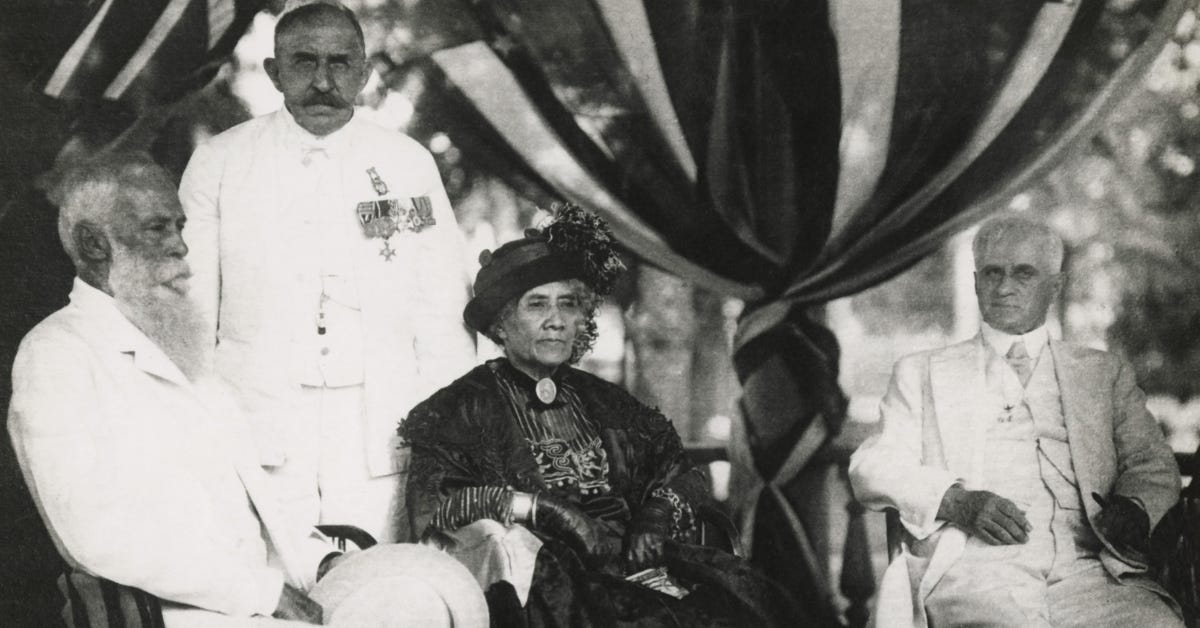 Queen Lili’uokalani on her 70th birthday, seated with Samuel Dole on her left; Lucius Eugene Pinkham, Territorial Governor, on her right; and behind her stands Henri Berger, Prussian composer and royal bandmaster, c. 1914.