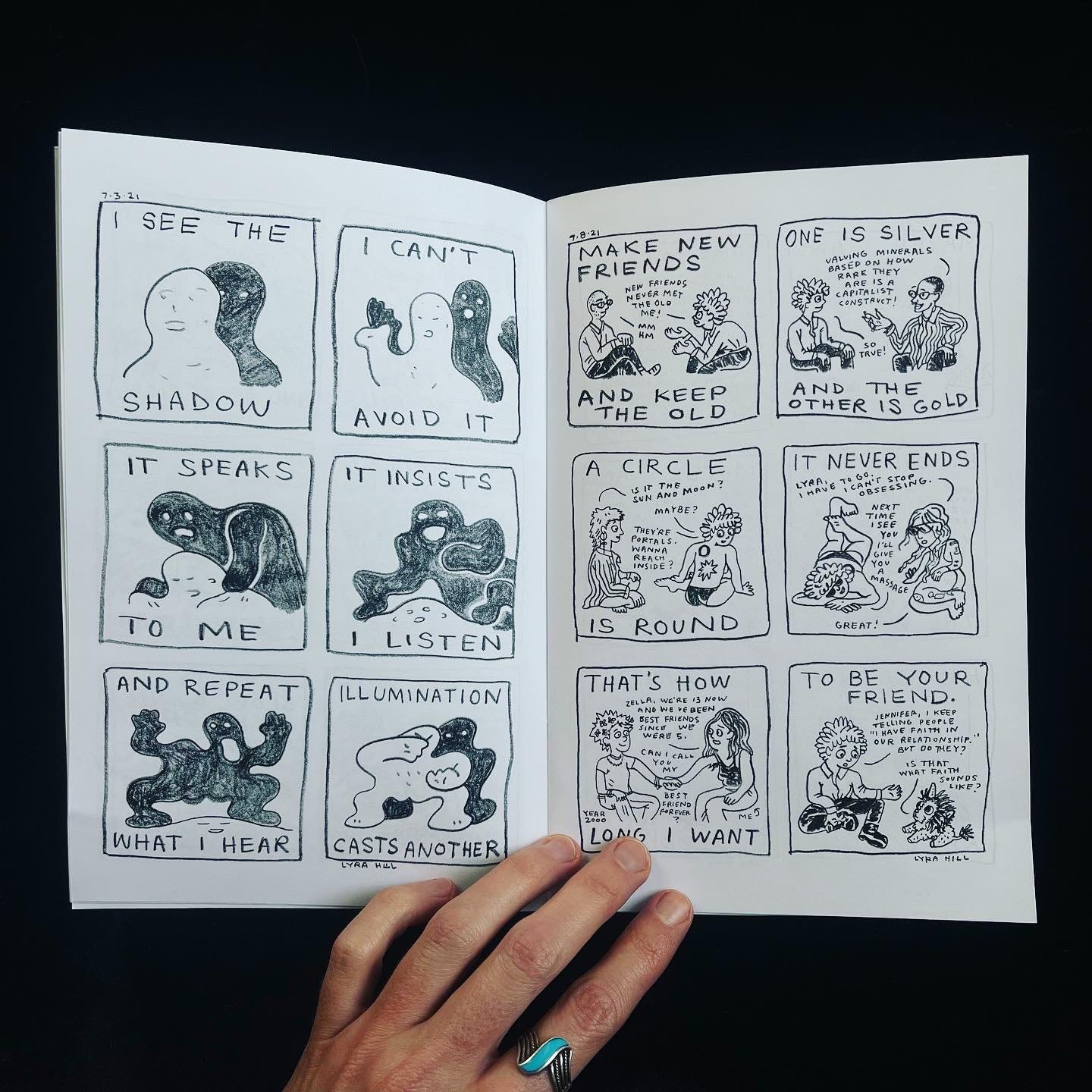 The new zine is open to a page showing two comics.
