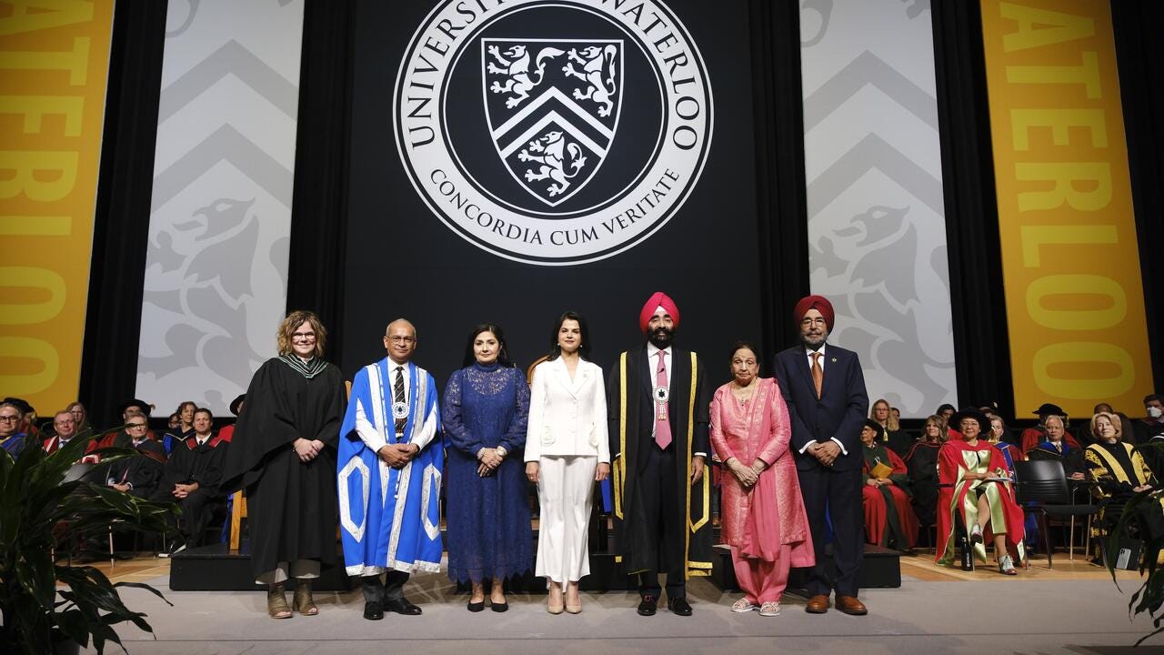 Dr. Jagdeep Singh Bachher stands on stage during convocation