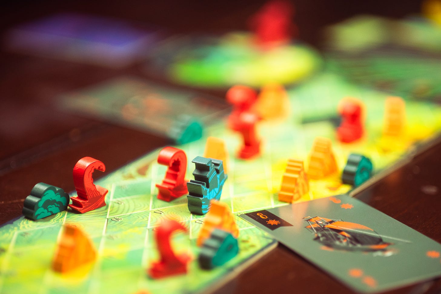 The board game Sail mid-play on a table. Several tentacles coming out of the water are depicted on the player board. The player ship is avoiding them.