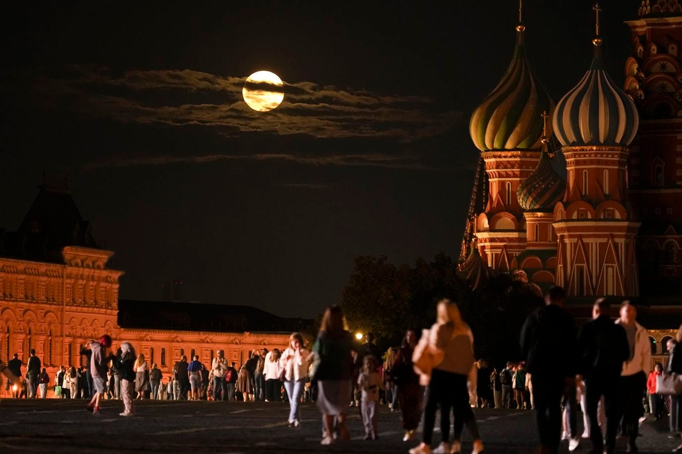 The super blue moon sets close to St. Basil's Cathedral, in Red Square, Moscow, Russia, on August 30.