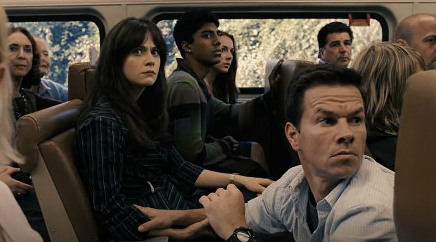 Several train passengers react with alarmed expressions as they witness something happening through the windows of their train, in a still photograph from the film "The Happening"