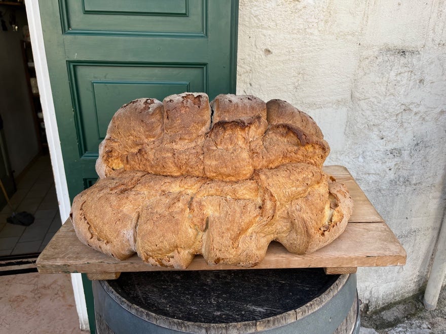 A loaf of bread on a wooden board

Description automatically generated