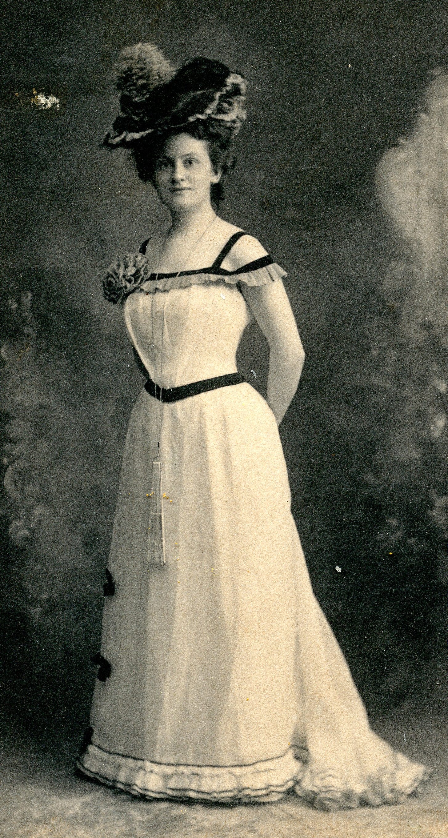 Woman with fancy hat and elegant gown