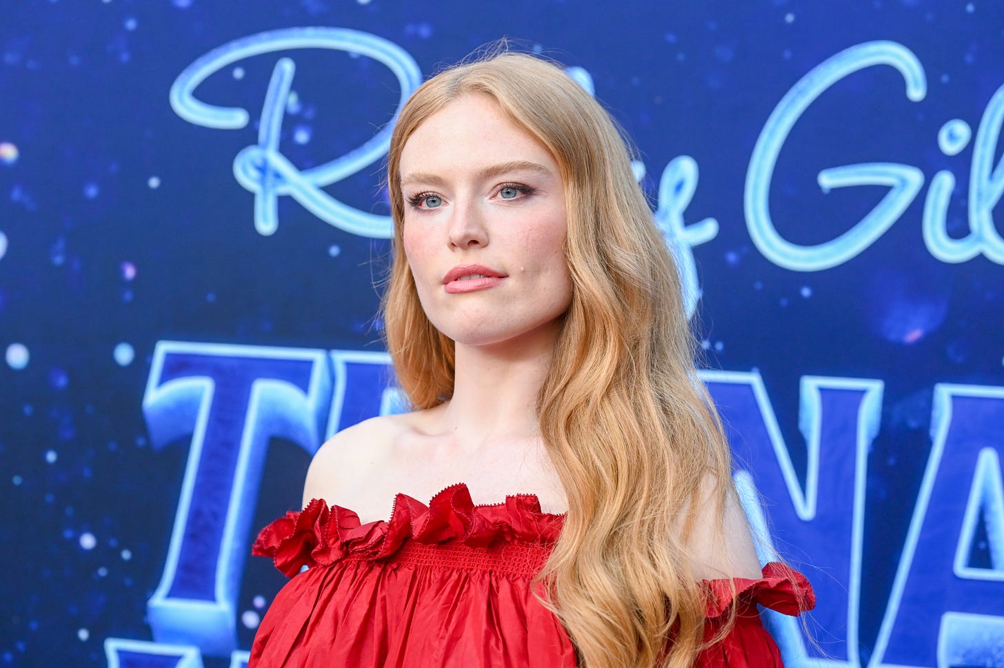 Freya Ridings in red off-shoulder dress and nude lipstick