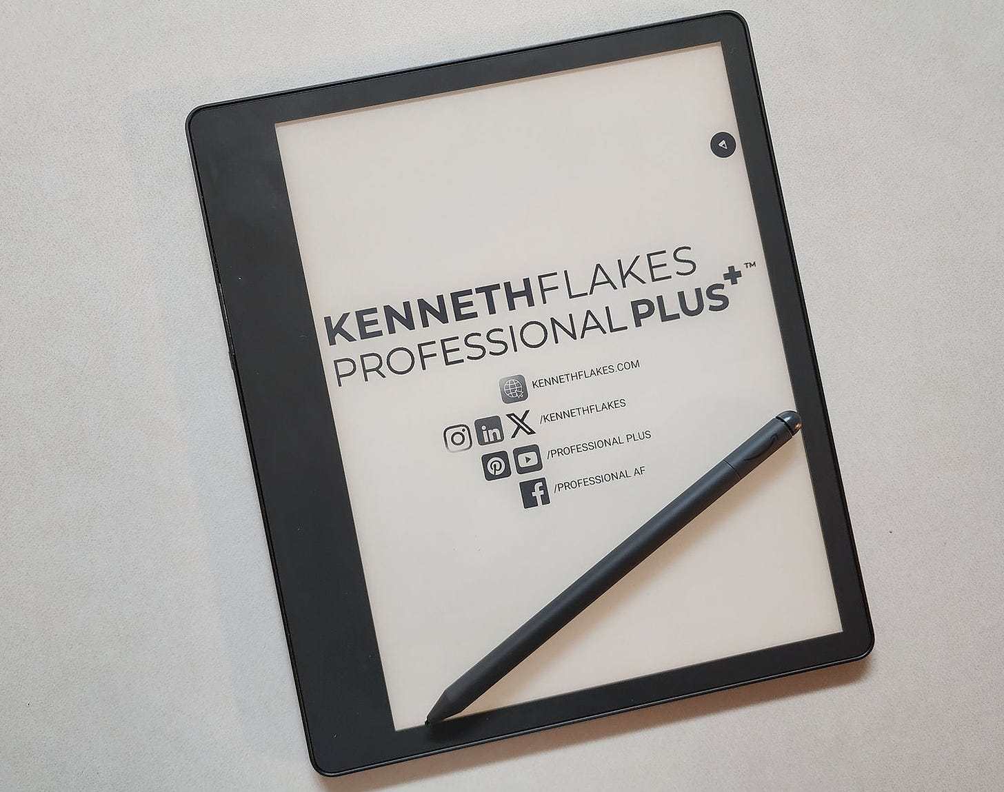 Kindle Scribe Tablet with the Kenneth Flakes Professional Plus logo and social media  