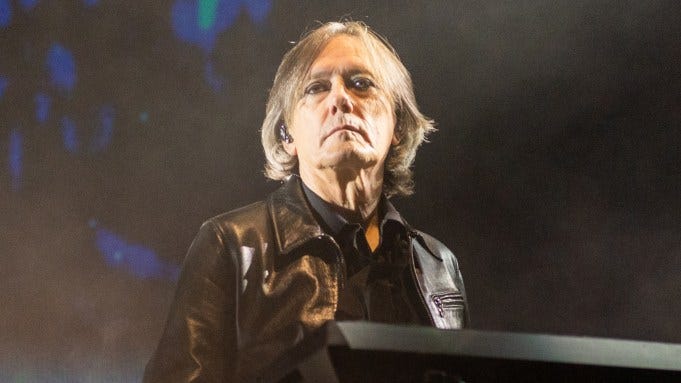 Roger O'Donnell looks at the crowd over his keyboard during a The Cure concert