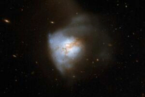 Astronomers have found evidence of magnetic fields associated with a disc of gas and dust a few hundred light-years across deep inside a system of two merging galaxies known as Arp220