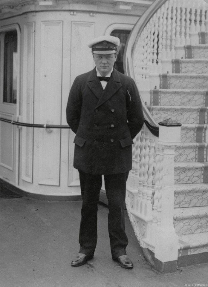 A person in a uniform standing on a staircase

Description automatically generated