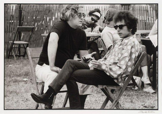 r/bobdylan - Bob Dylan talks with Albert Grossman backstage at the 1965 Newport Folk Festival