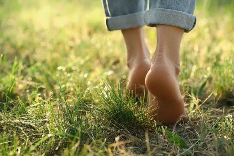 Close-up of a person's feet walking on grass

AI-generated content may be incorrect.