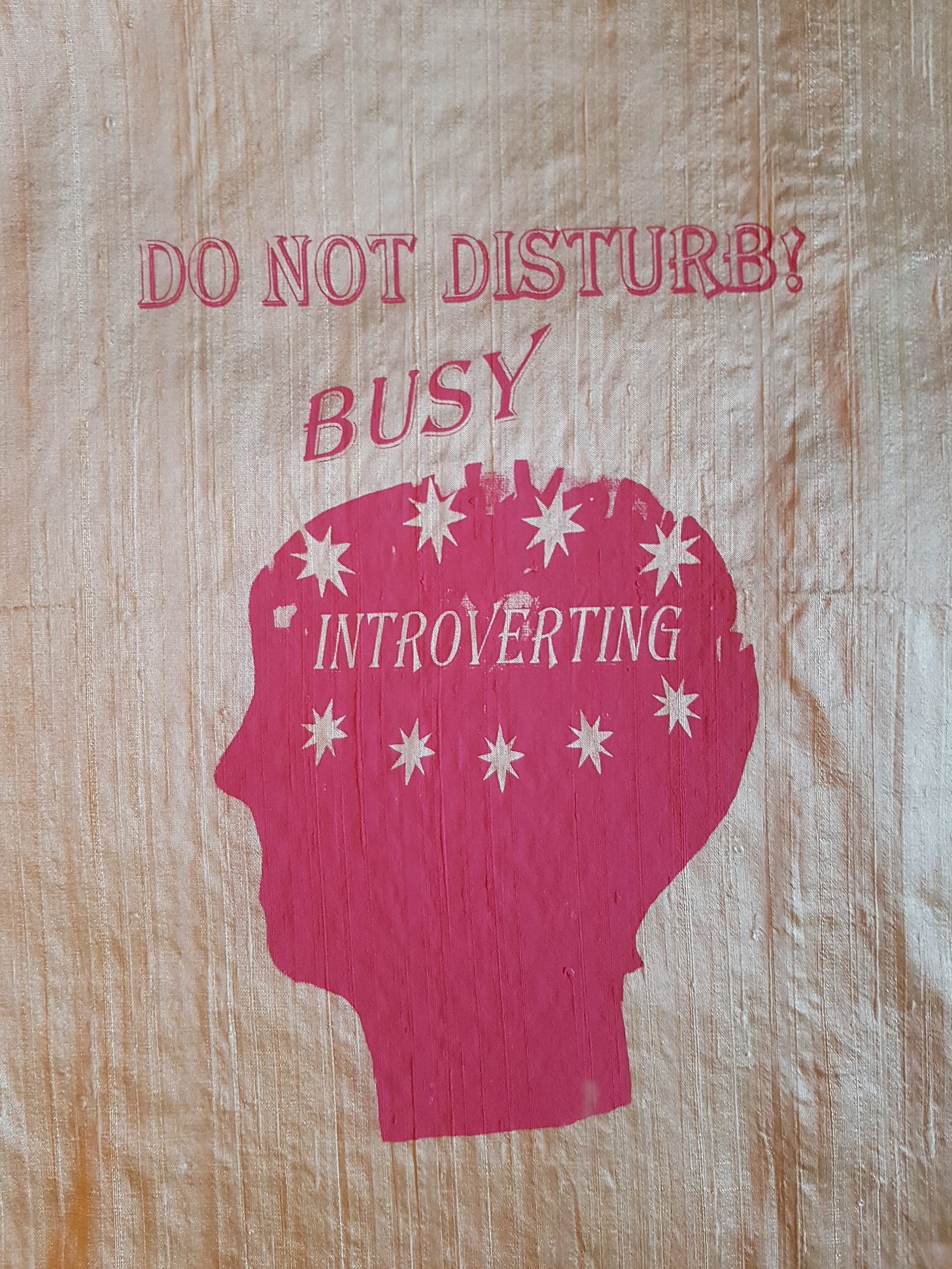 Gocco printed design on silk fabric shows pink text 'Do not disturb, busy, introverting!' with head in profile.