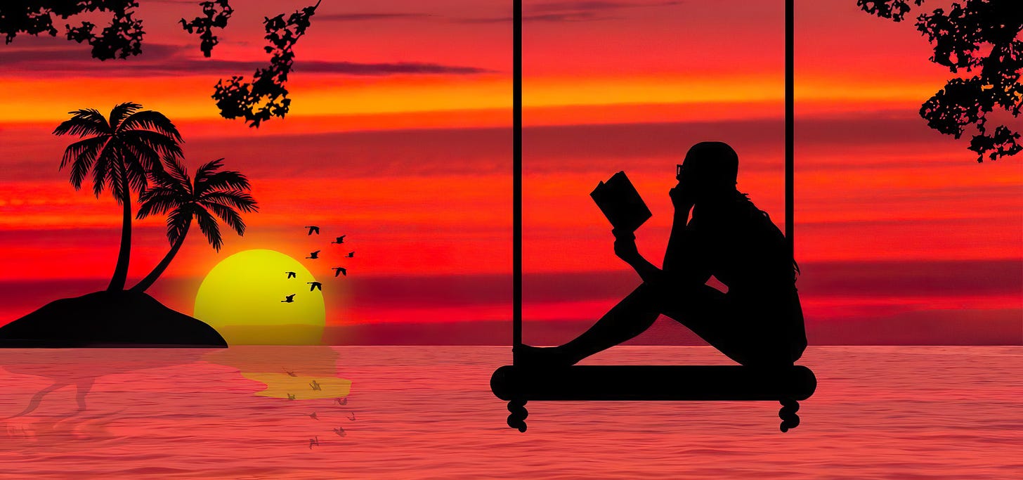 Girl reading by ocean at stunning sunset.