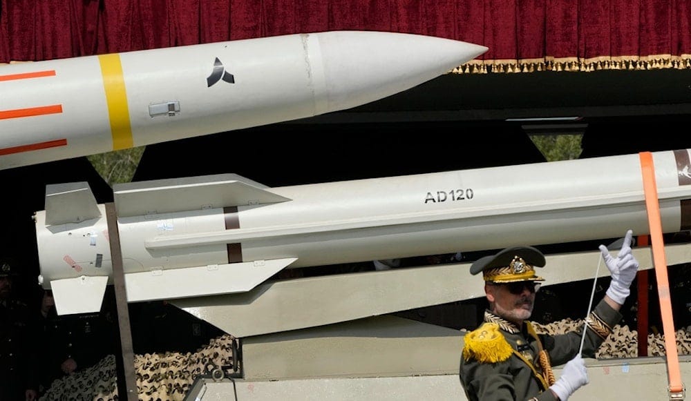 Missiles are carried on a truck as an Iranian army band leader conducts the music band during the Army Day parade at a military base in northern Tehran, Iran, Wednesday, April 17, 2024 (AP) Missiles are carried on a truck as an Iranian army band leader conducts the music band during the Army Day parade at a military base in northern Tehran, Iran, Wednesday, April 17, 2024 (AP)