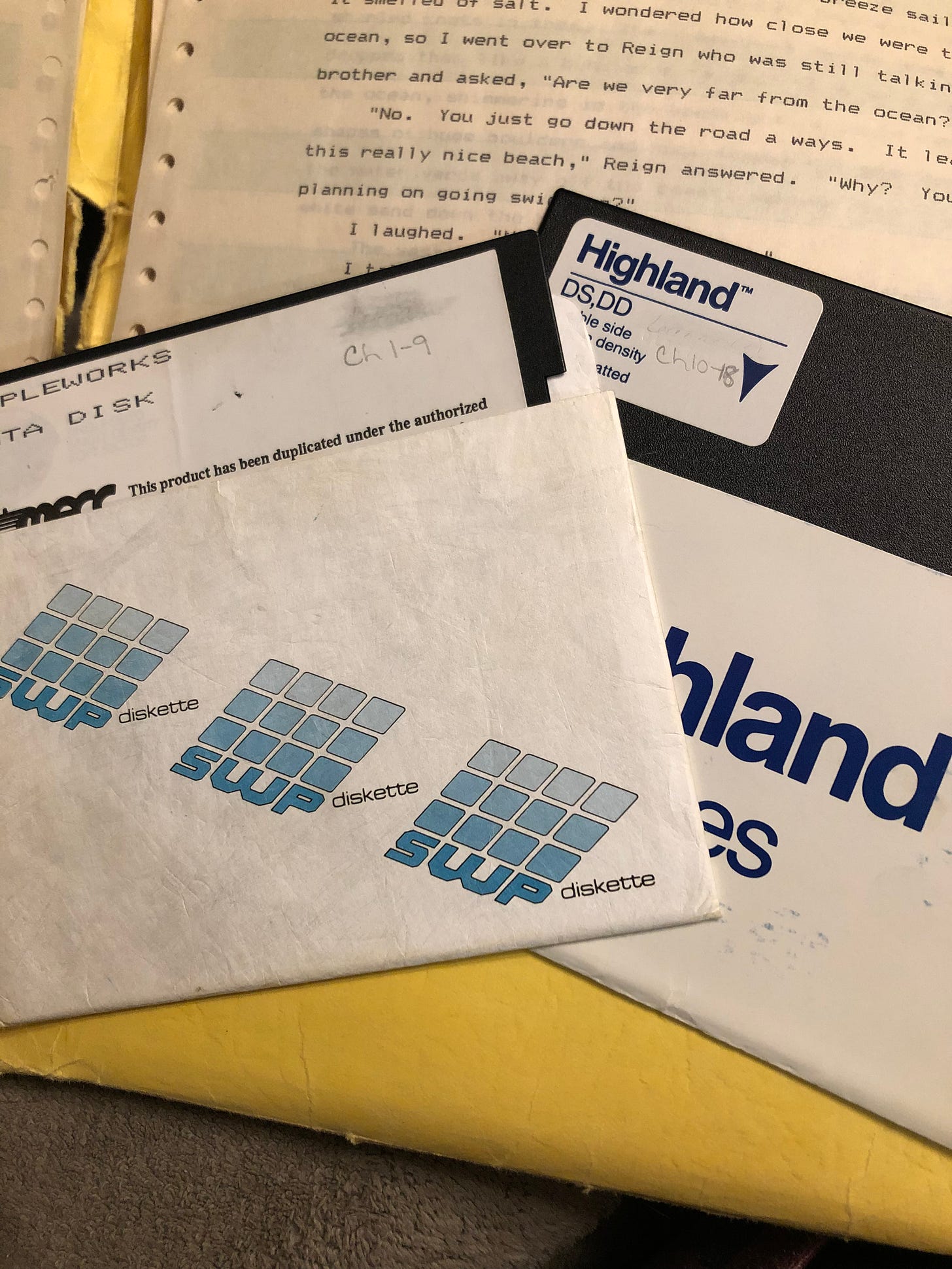The floppy disks and a page of the printout on the yellow folder.