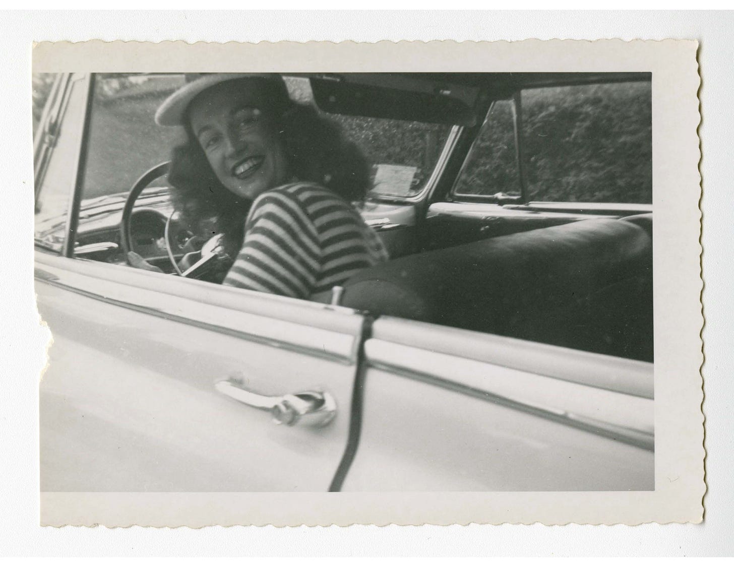 Lisa Ben in a front seat of a car turning to smile at the camera