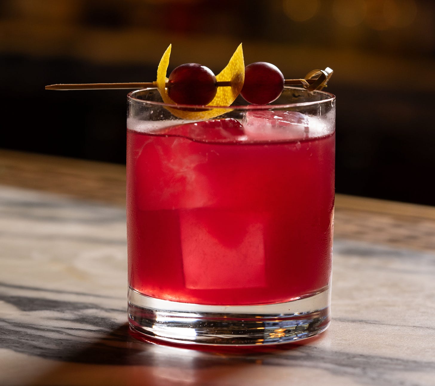 concord grape negroni in a rocks glass with grape garnish