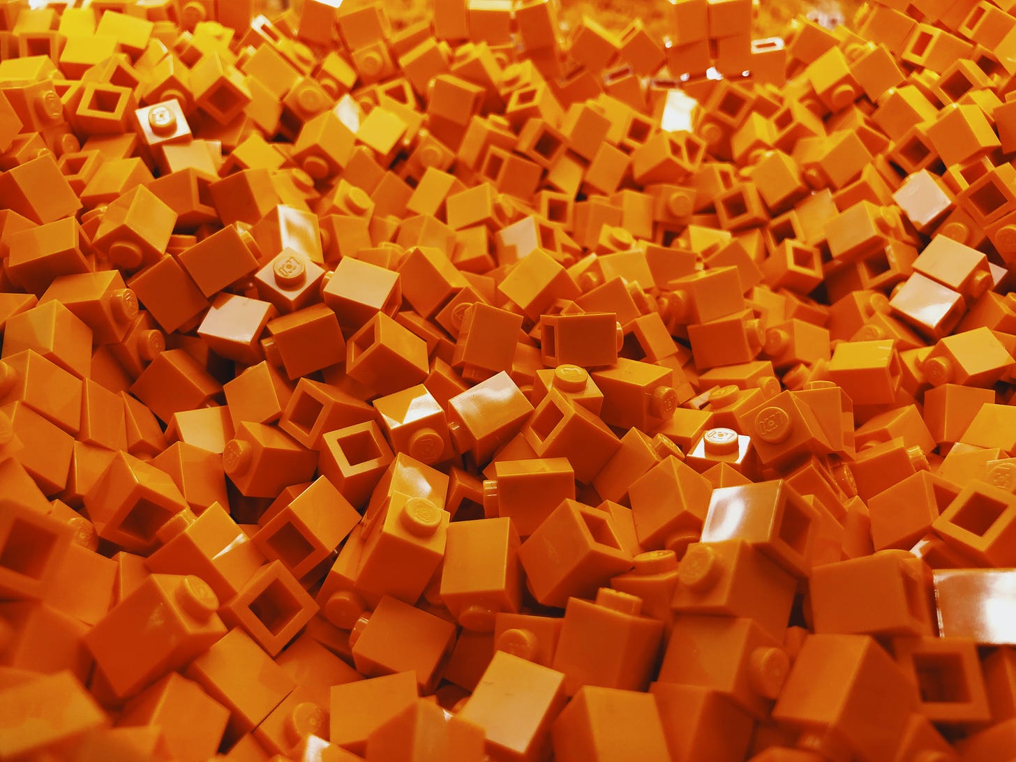 A large pile of orange Lego bricks.