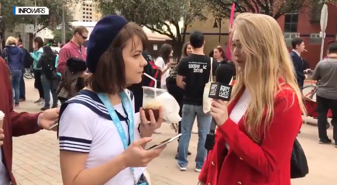 A blonde Ashton Blaise, in a bright red blazer holding an InfoWars branded mic, interviews Dasha, dressed like Sailor Moon and holding an iced coffee, in 2018.