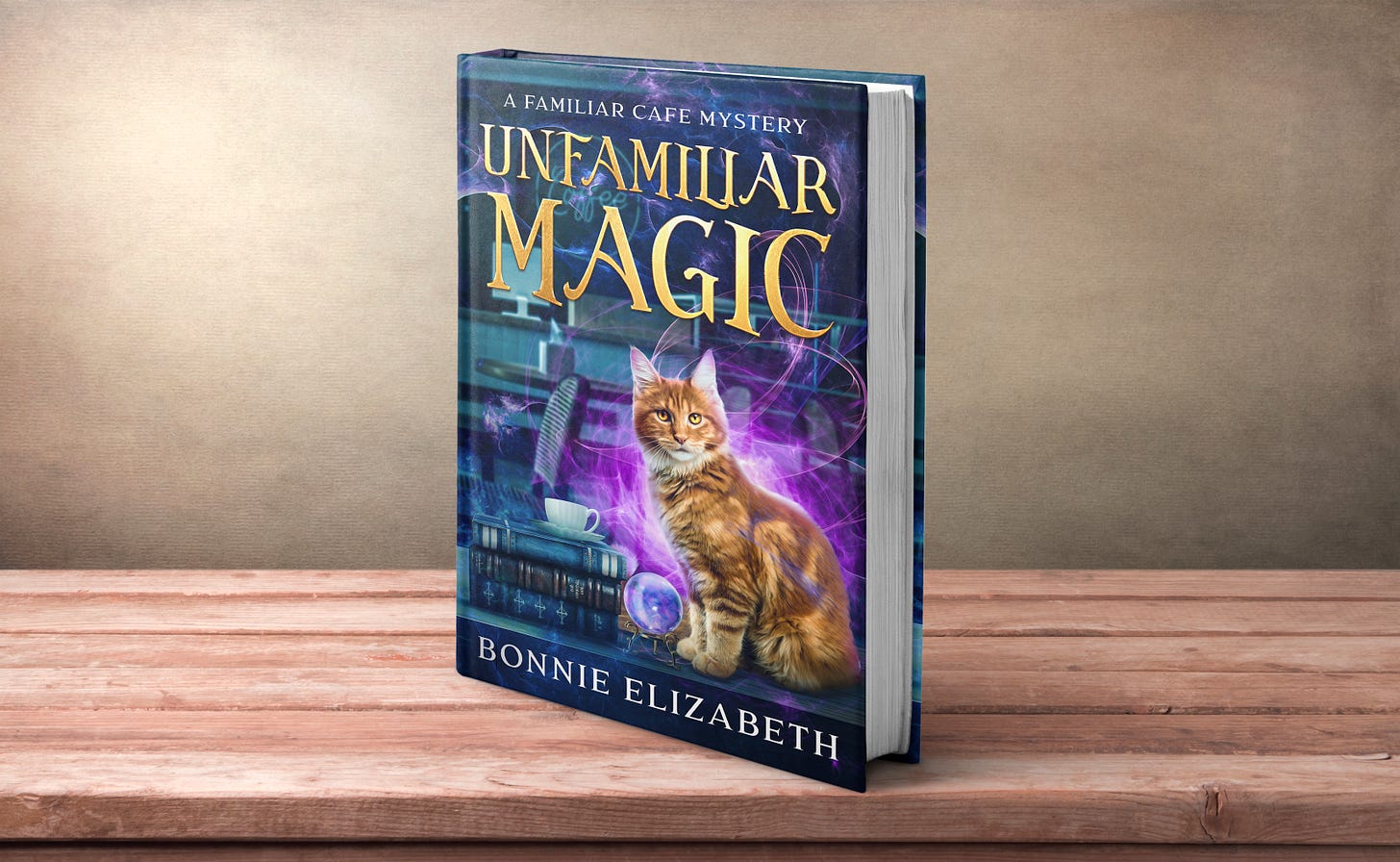 An orange cat sits on the background of a coffee shop shaded in blues, purples, and greens. Near him is a pile of books, a coffee cup, and a crystal ball. Purple magical swirls surround him. This is the new cover of Unfamiliar Magic