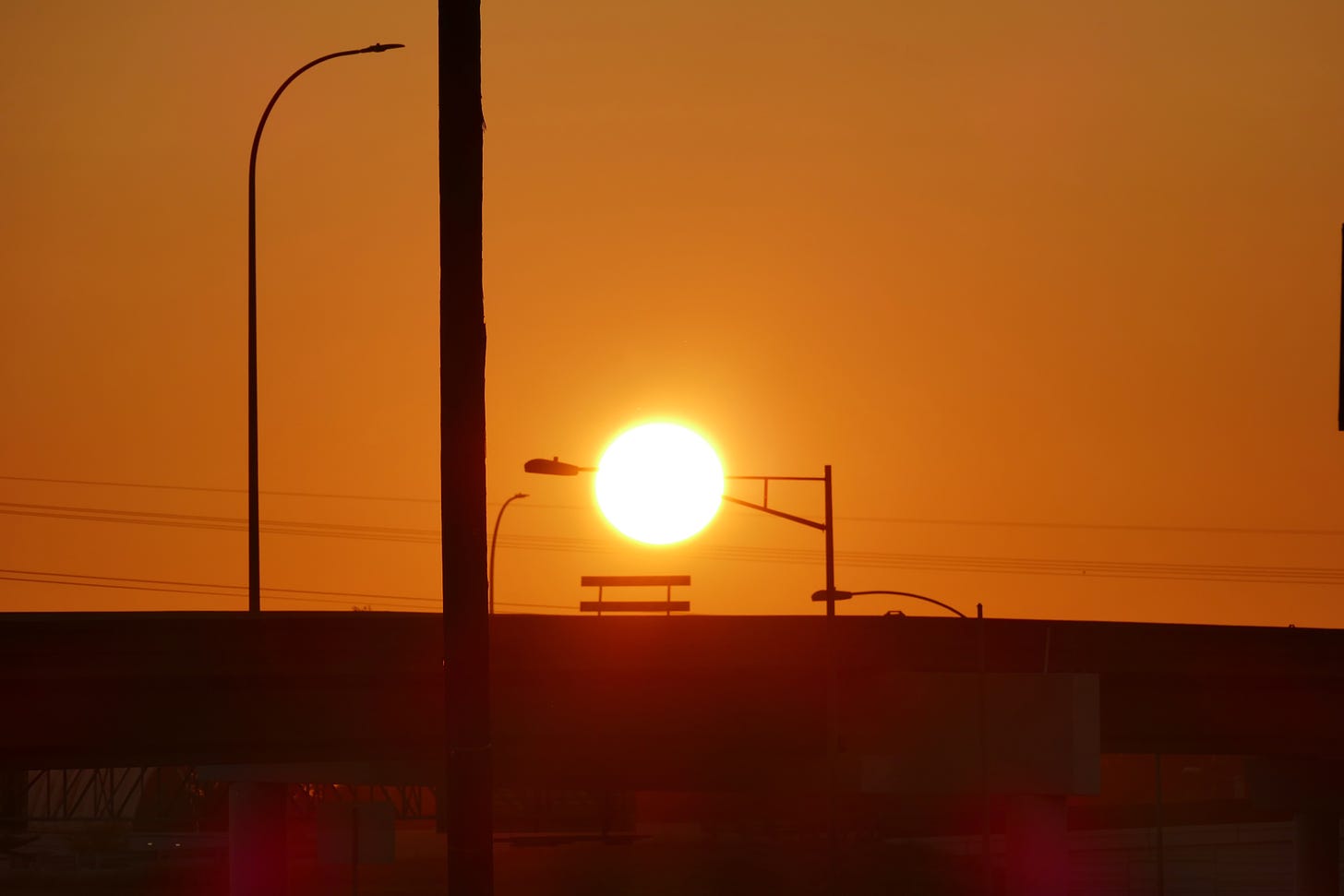 Orange sunrise over freeway