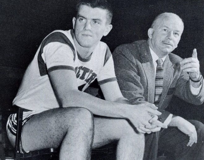Saint Peter's coach Don Kennedy (right) sits with his son, Don, during a game.
