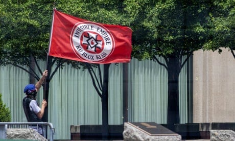 a person flies a KKK flag