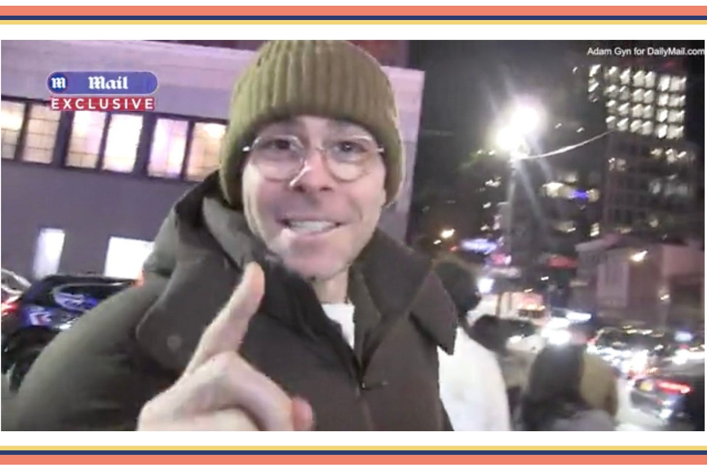 Adam Mosseri in a beanie and coat pointing his finger at a Daily Mail photographer on the streets of New York and smiling