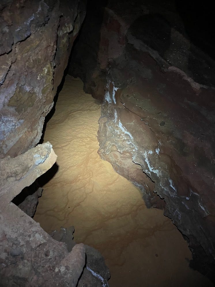 A light brown calcite coating in the floor of a canyon