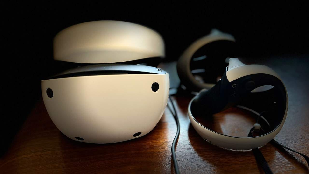PSVR 2 headset and Sense controllers on a wooden table