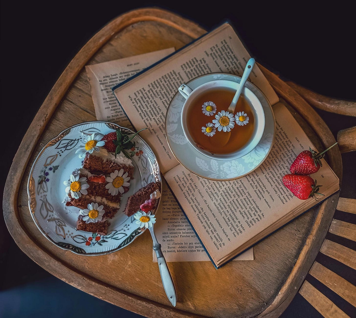 Top View of a Slice of Cake and a Cup of Tea Decorated with Daisies